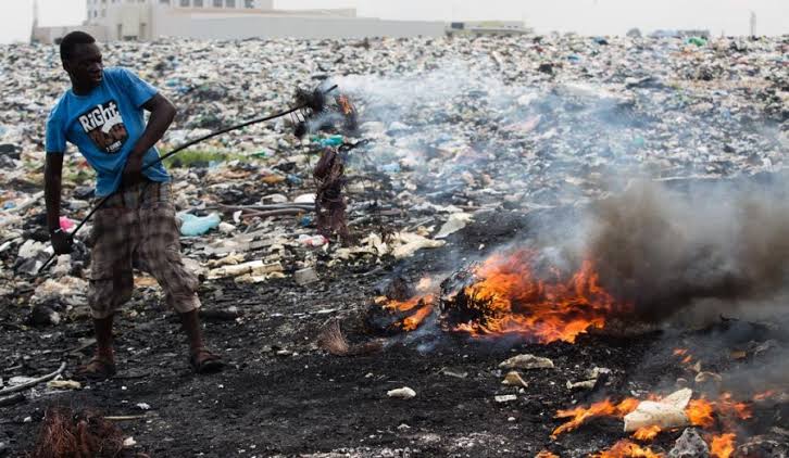 Informal worker burns cable to extract valuable metal from the e-waste