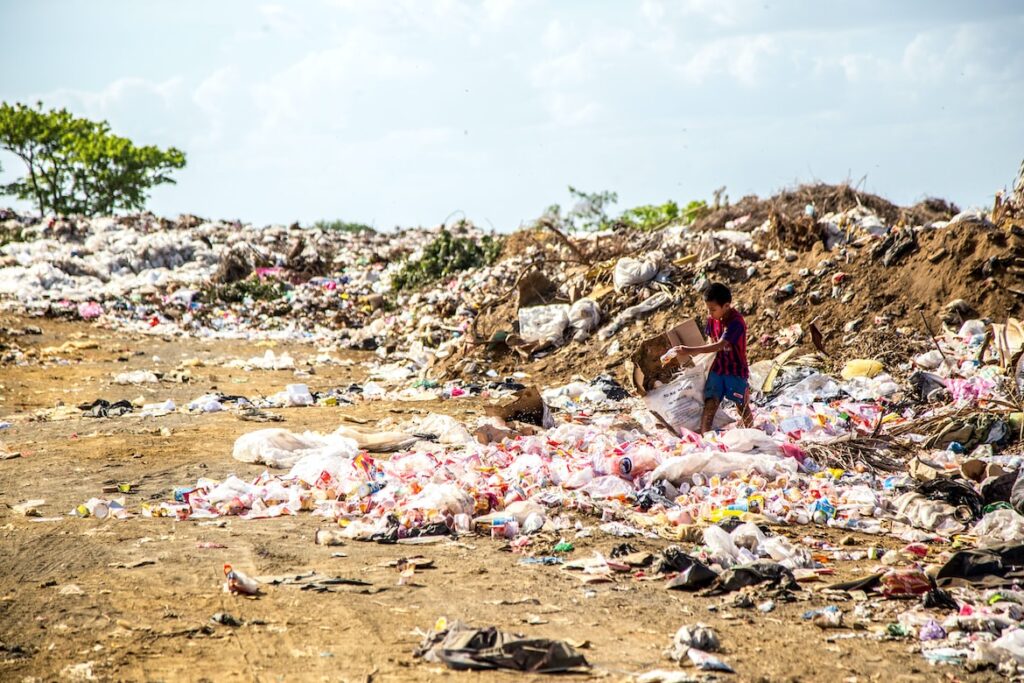 A child searching for e-waste in a pile of garbage